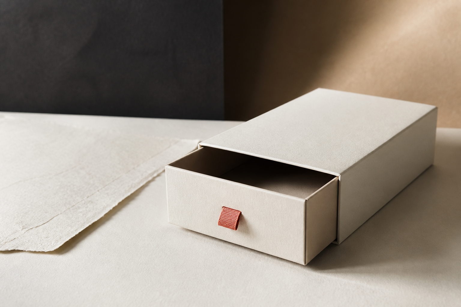 Refined unbranded presentation packaging showing structure tactile paper restraint and considered opening experience